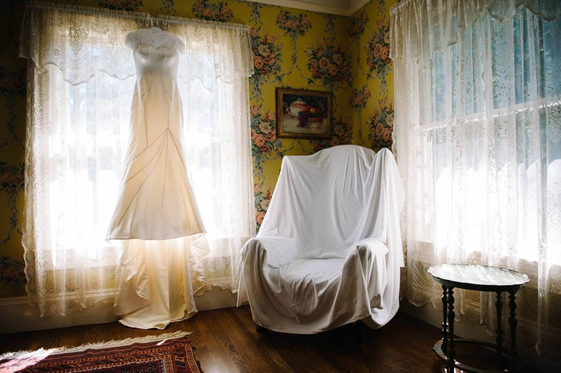 Fun, Artistic, and inspiring image of wedding dress against floral wall paper at Atherton Wedding