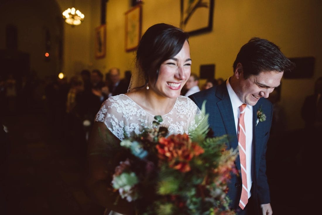 Couple leaving Presidio Chapel after wedding
