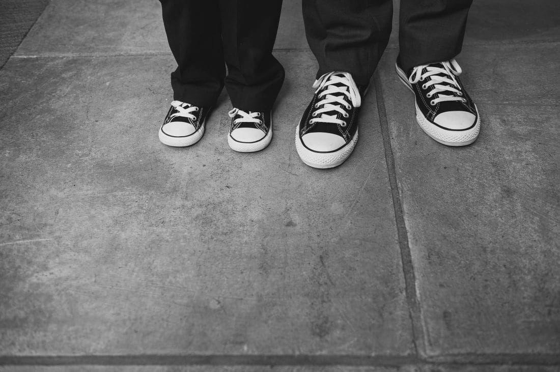 Artistic wedding detail of adult and kid wearing converse