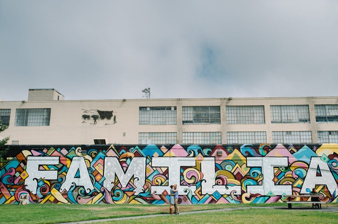 Artistic San Francisco Engagement with familia in back ground