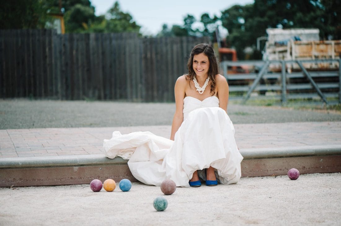 Fun portrait of bride in bocci ball court at sonoma garden pavilion wedding